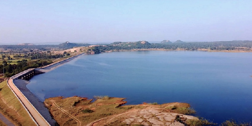 An image of Rengali Reservoir, a lake in Odisha, with vast blue waters surrounded by green hills.