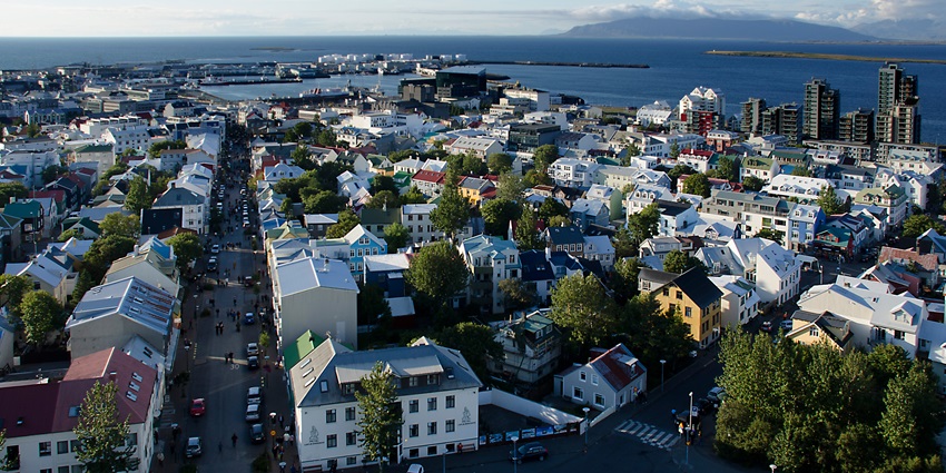An image showing Reykjavík, viewed from Hallgrímskirkja spire, overlooking downtown and the harbour