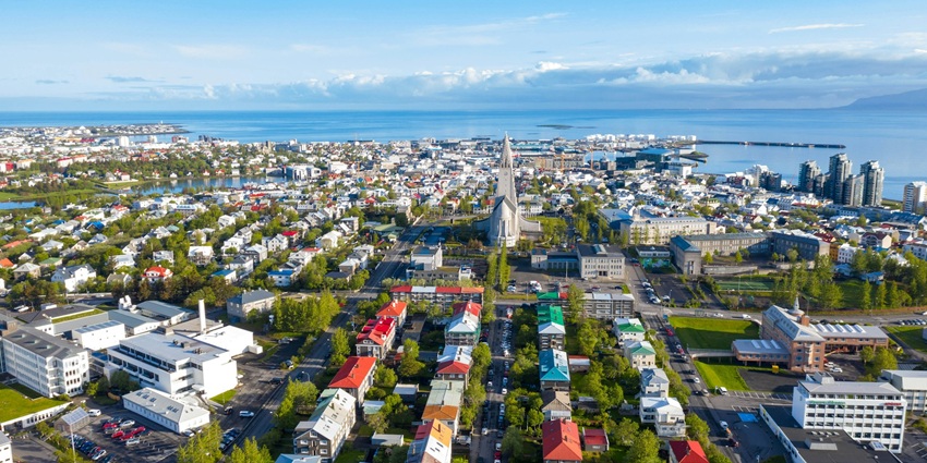 A vibrant capital city surrounded by stunning waterfalls, geysers, and volcanic landscapes