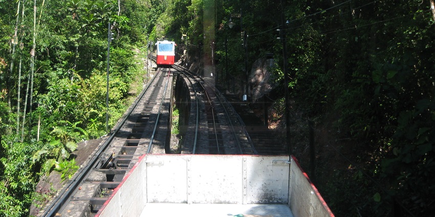 The Penang Hill Funicular Railway is about to ascend through lush greenery.