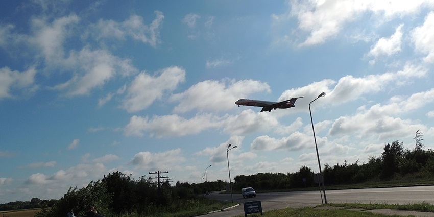 An aeroplane takes off from Rivne International Airport as a person captures the moment on the phone