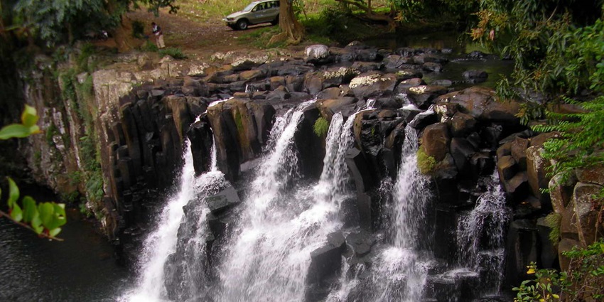 A picture of Rochester Falls, with cascading waters over volcanic rocks during the day.