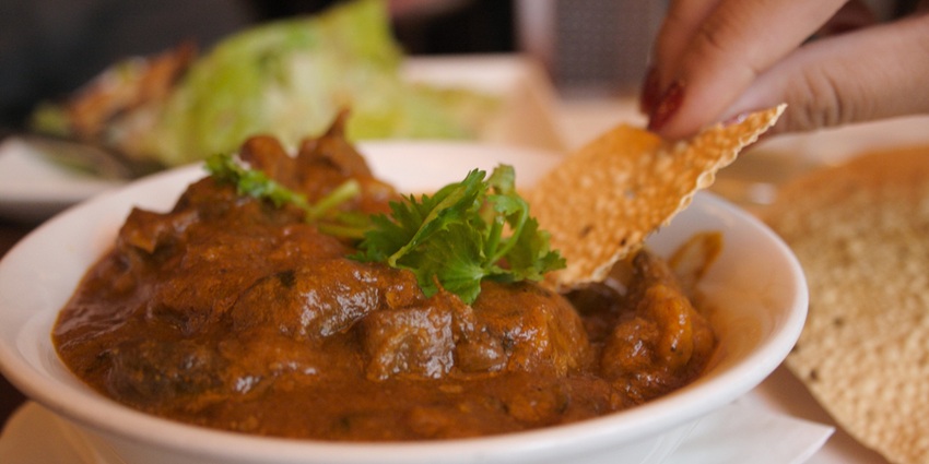 Kashmiri rogan josh with tender lamb in a deep red curry, usually served with rice or naan