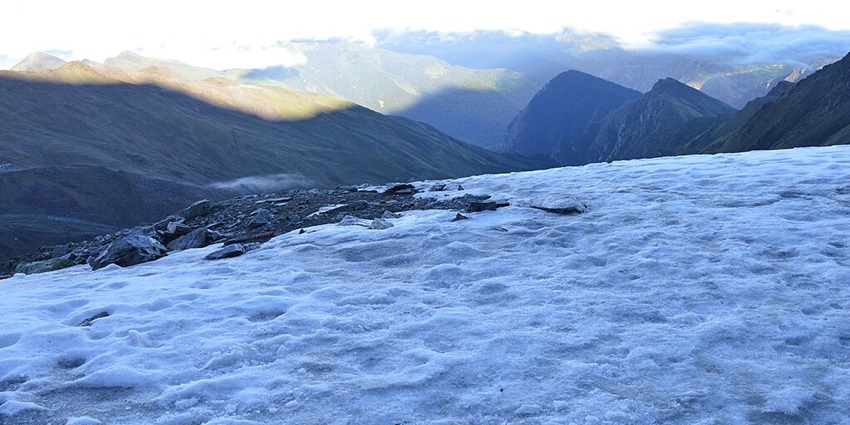 The mysterious Roopkund Lake, surrounded by snow, is a thrilling site for Himalayan treks