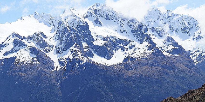 An image of Tuhawaiki Mountain, viewed from the Routeburn Track, featuring rugged slopes