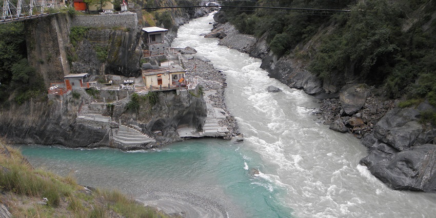 A view of Rudraprayag in Uttarakhand, India, showing green hills and a winding river