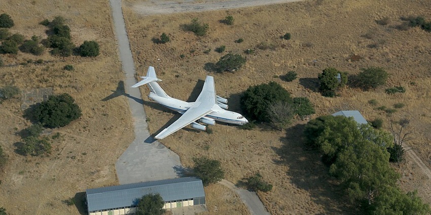 An Ilyushin Il-76 cargo plane is currently stationed at Rundu Airport on a dry land