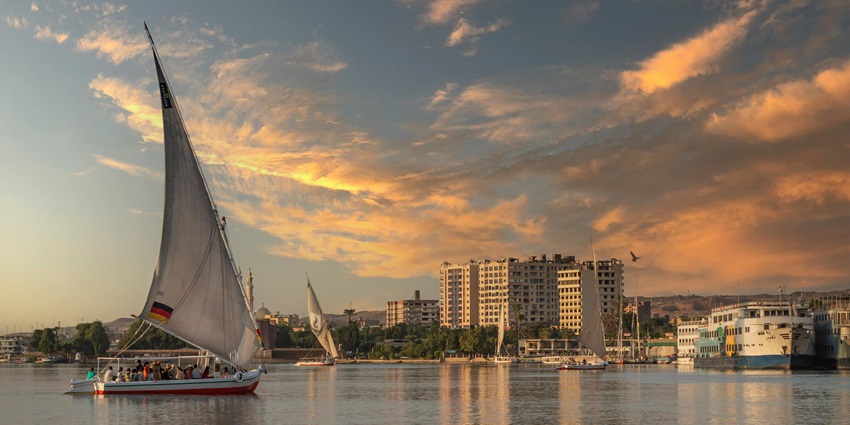 An image of the Nile River with serene waters and lush riverbanks, showcasing things to do in Aswan.