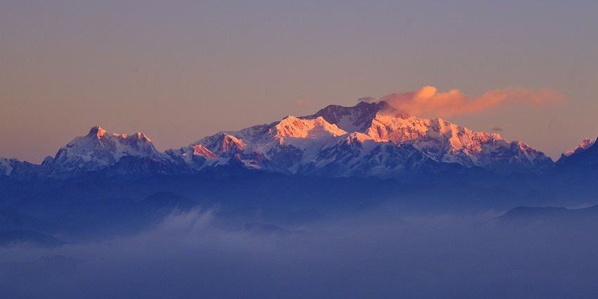 An image showing Kanchenjunga visible from the Sandakphu trek with mountain trails in view