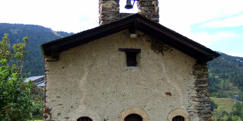 The medieval church of Sant Pere del Tarter with an arched roof and bell on top