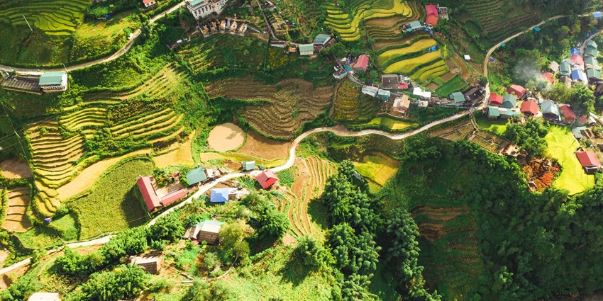 An aerial view of lush green manicured lawns and quaint colourful houses of Sapa.