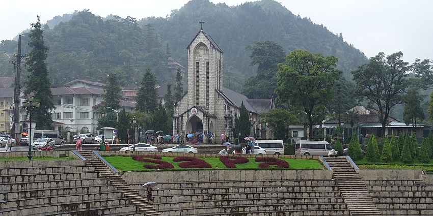 A photo of Sapa Town, nestled among foggy mountains and rice terraces
