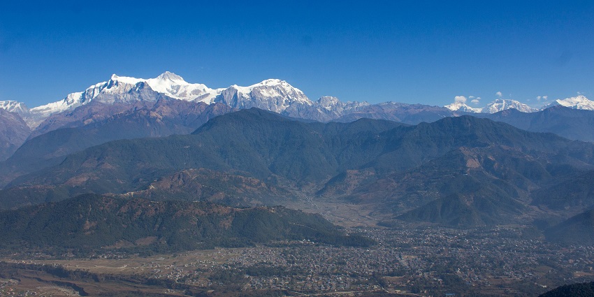 A mesmerizing view of Sarangkot, Pokhara, with clouds covering the sky during sunrise
