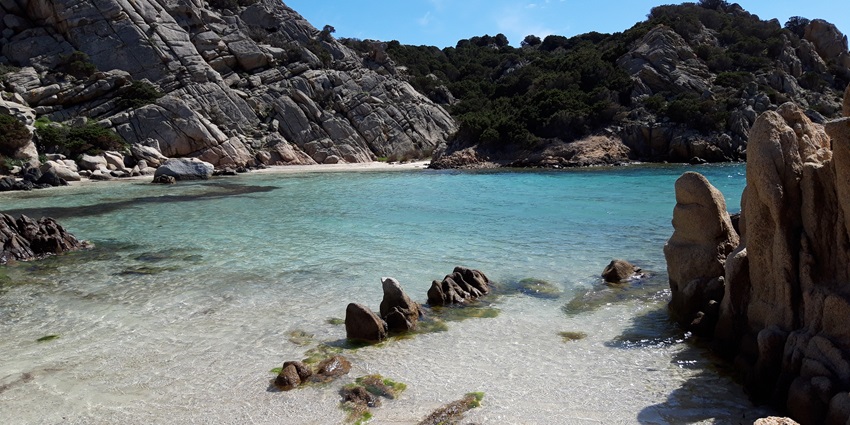 A stunning aerial view of Sardinia, showcasing its rugged coastline and deep blue waters.