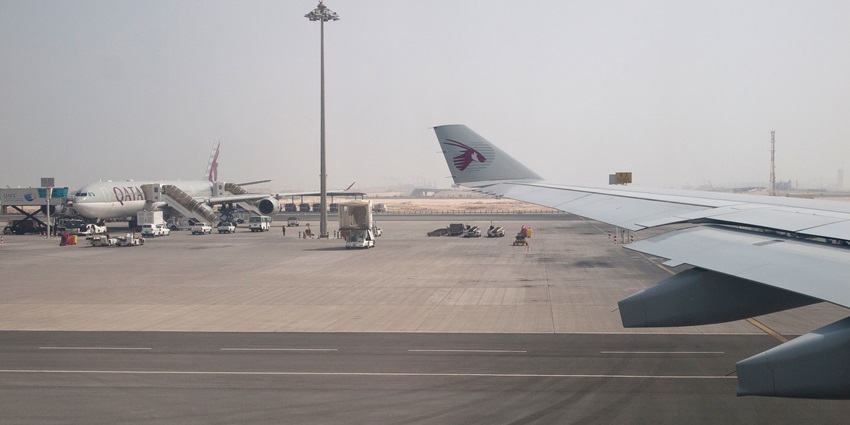 A Qatar Airlines aircraft is getting ready for takeoff, as seen from a moving aircraft
