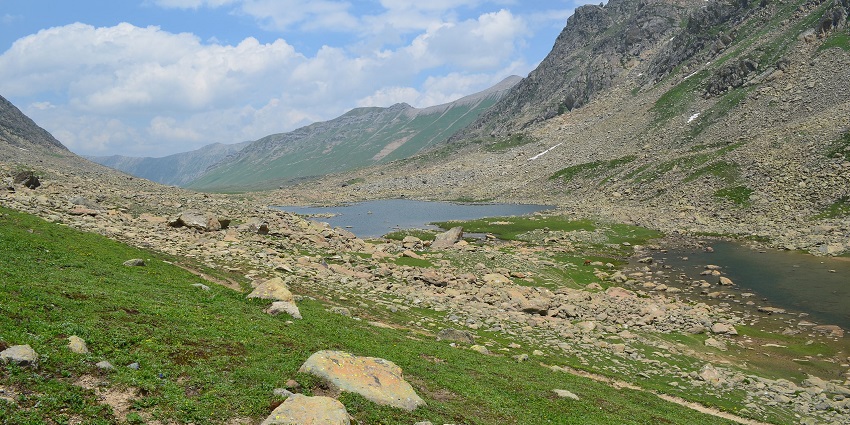 Satsar lakes with multiple small lakes surrounded by rocks and hills under a clouded sky