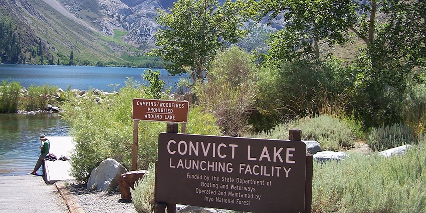 Path leading to the convict lake with a sign board, the lake - things to do in mammoth lakes in april