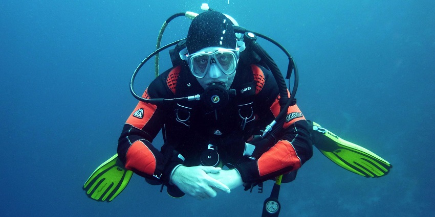 An image showing scuba diving activity, with a diver exploring underwater surroundings.
