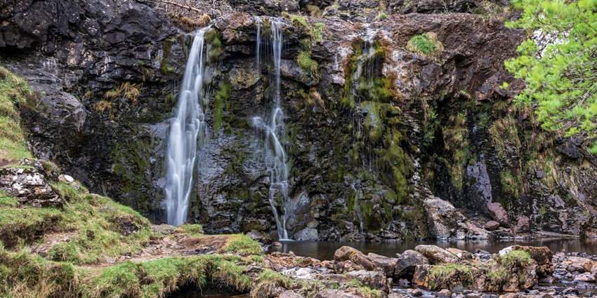 Seganing Waterfall is a hidden gem requiring a challenging trek to a secluded cascade amid rocky cliffs.