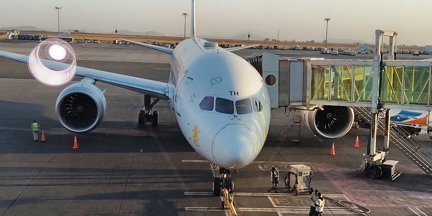 Front view of an Ethiopian Airlines plane in Semera Airport in Ethiopia with workers preparing for ground operations.