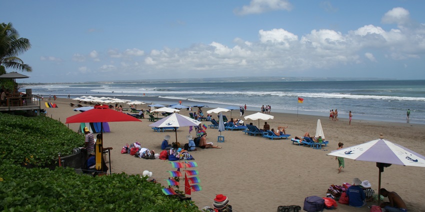Seminyak Beach offers upscale vibes with chic boutiques, beach clubs, surfing waves.