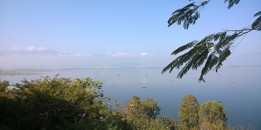 Sendra island and viewpoint with a large water body of Loktak Lake and green trees.