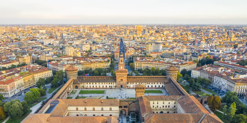 The grand tower of Sforzesco Castle in Northern Italy’s Milan against a backdrop of blue sky.