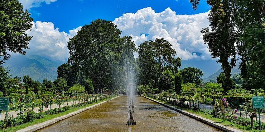 Shalimar Bagh with distant mountains, houses and buildings surrounded by greenery