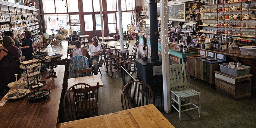 Cosy boutique interior with rustic wooden shelves, decorative pieces, and fashion accessories neatly displayed.