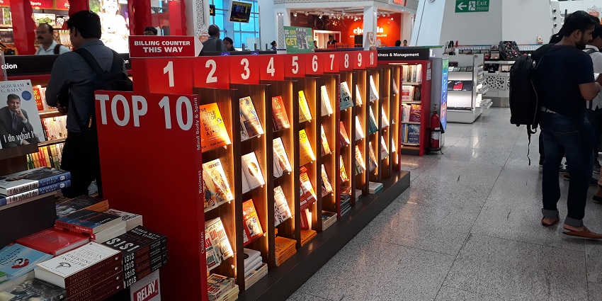 Image of a luxury shopping area inside Delhi Airport featuring top international brands.