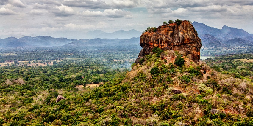 View of Sigiriya Rock Fortress, showing its impressive height and ancient ruins at the top