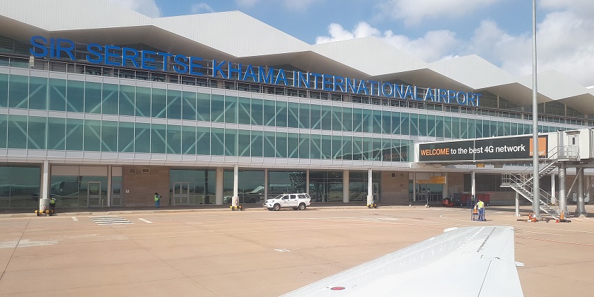 Workers are cleaning the pavement outside of Sir Seretse Khama International Airport.