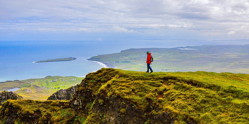 An image showing a man hiking on an island, a famous place near Blombos Cave.