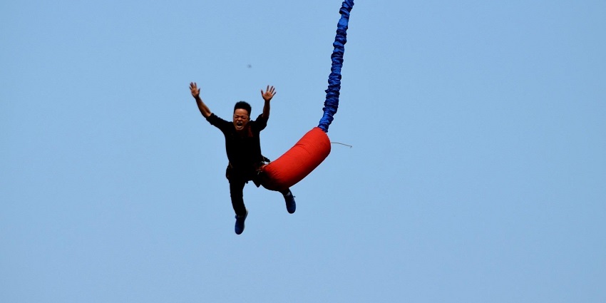 An image of a man reverse bungee jumping in Slingshot in Blackpool, UK.