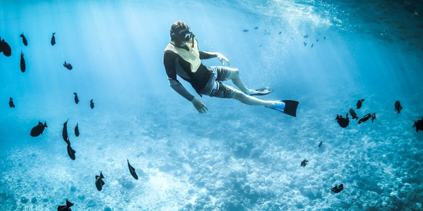 Image of a traveller snorkeling, one of the adventurous activities in Guam travel guide