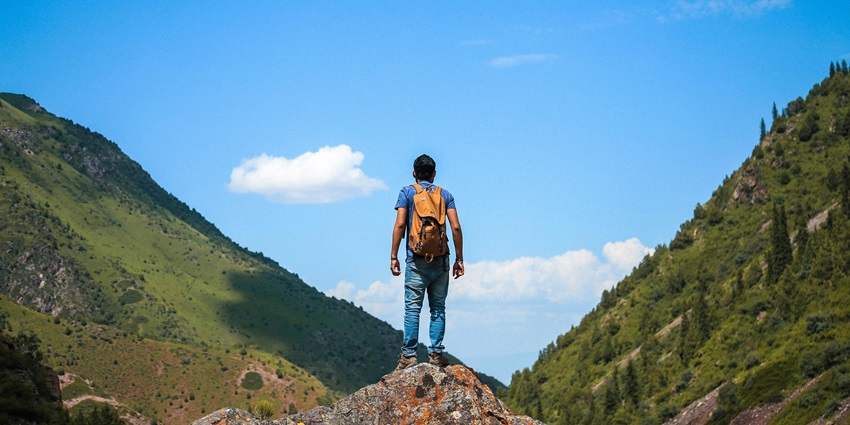A hiker with a backpack in Bhutan, one of the places for trekking in February.