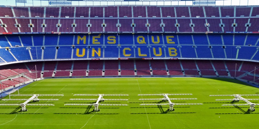Empty Camp Nou stadium in Barcelona with “Més Que Un Club” written across the seats.
