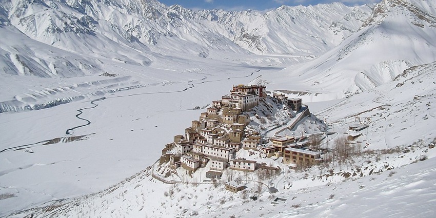 Key monastery covered in snow in the snow-covered Spiti valley and river flowing through