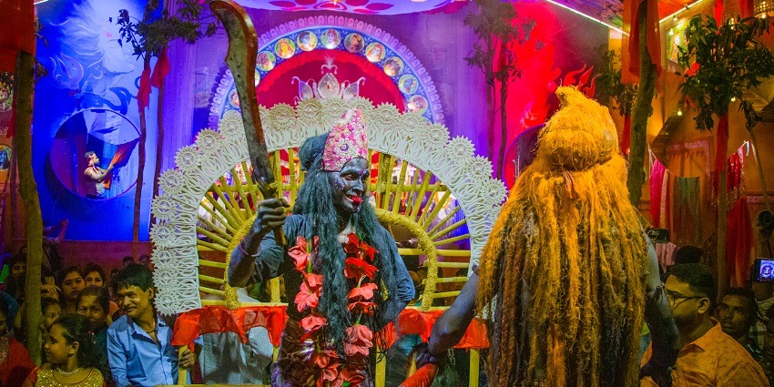 An image showing devotees participating in traditional rituals during the Gajan Festival in Bengal.