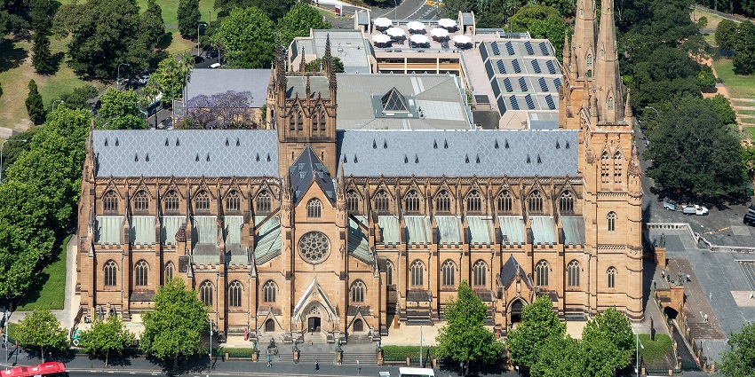 Aerial view of St. Mary’s Cathedral, showing its grand structure amid city landscapes.