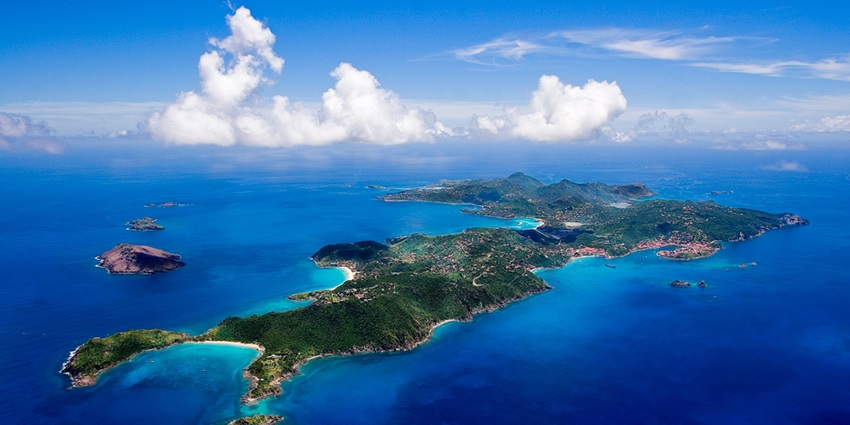 St. Barts combines luxury boutiques and fine dining with secluded beaches and clear waters.