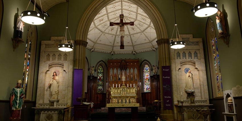 Inner view of St. Patrick's Church Sydney showcasing stunning stained glass and grand interiors