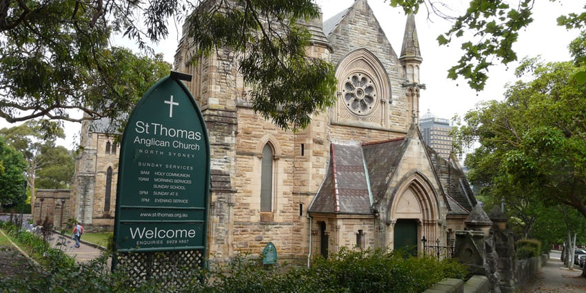 St. Thomas North Sydney with a welcome board, surrounded by lush greenery and a peaceful vibe