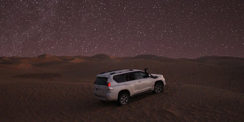 The sky is filled with stars, perfect for stargazing during a night safari in Dubai.