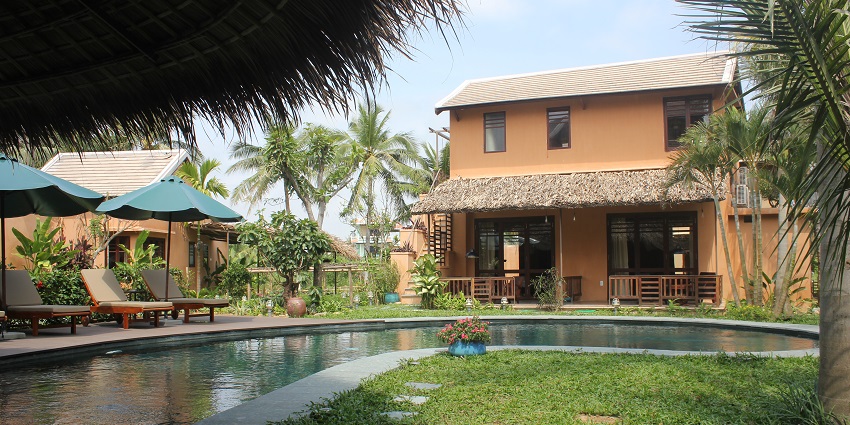 An image of a boutique villa in Hội An at night, featuring warm exterior lighting.