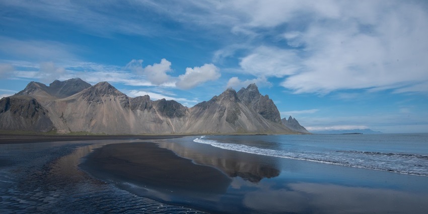 A high cliff at the Stokksnes Beach, one of the black sand beaches in the world.