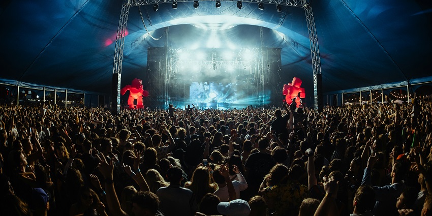 An image of Storm Festival in Coorg, with a lively outdoor music stage at night.