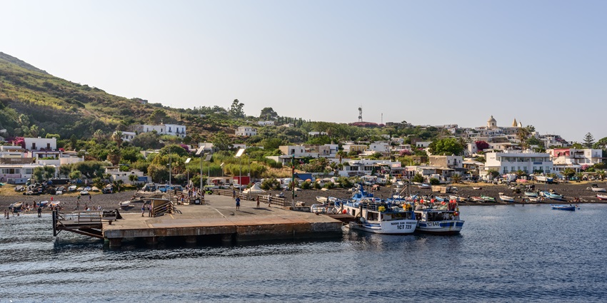 Scenic view of Stromboli Island with boats docked, one of the islands in Italy for honeymoon.