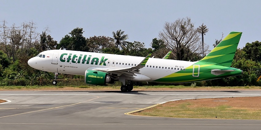 A Citilink Airbus touches down at a runway in Presidente Nicolau Lobato International Airport.