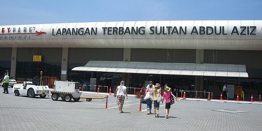 An exterior view from the tarmac shows people approaching Sultan Abdul Aziz Shah Airport.
